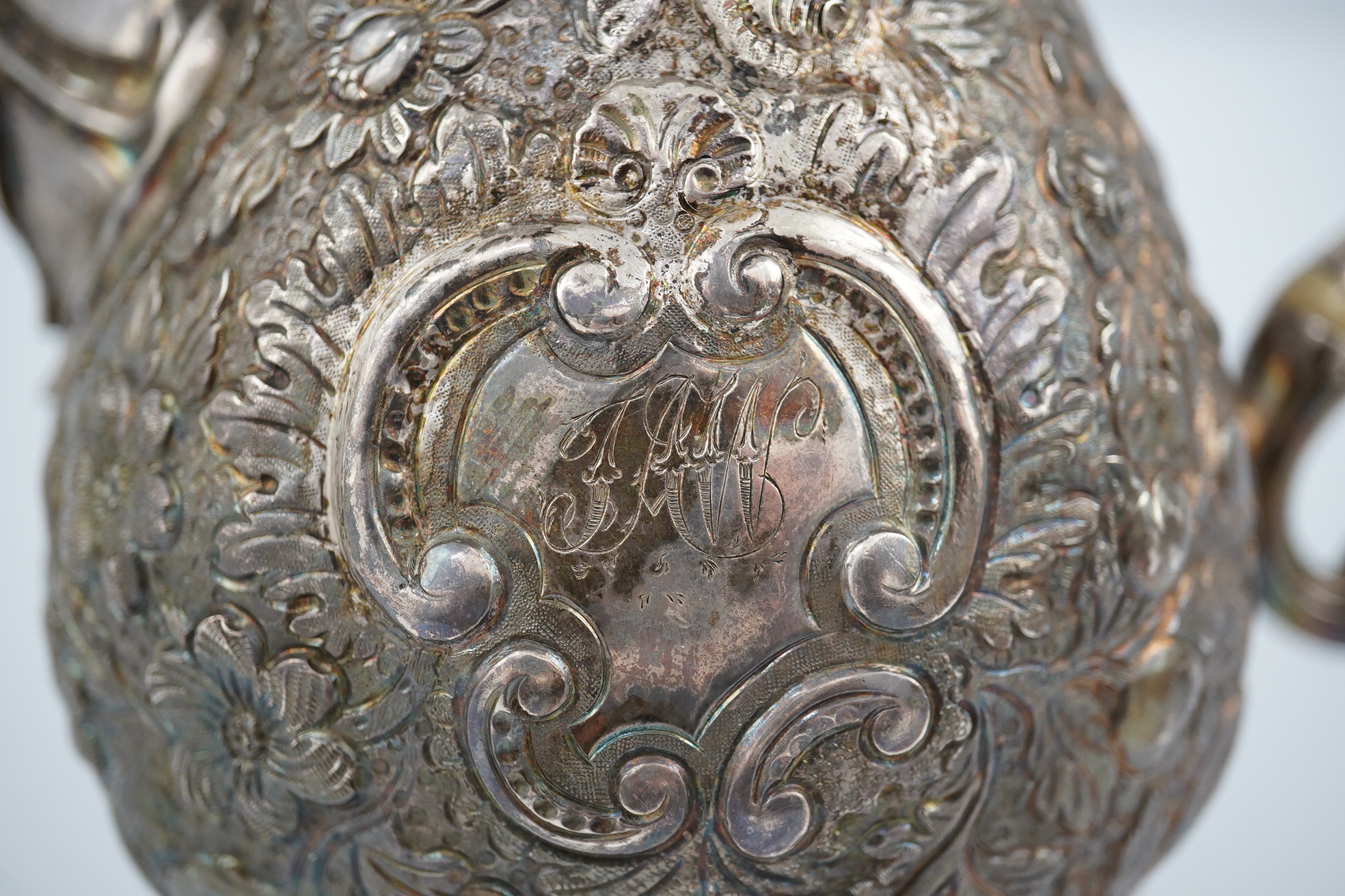 A George III silver pedestal coffee pot, with later embossed decoration